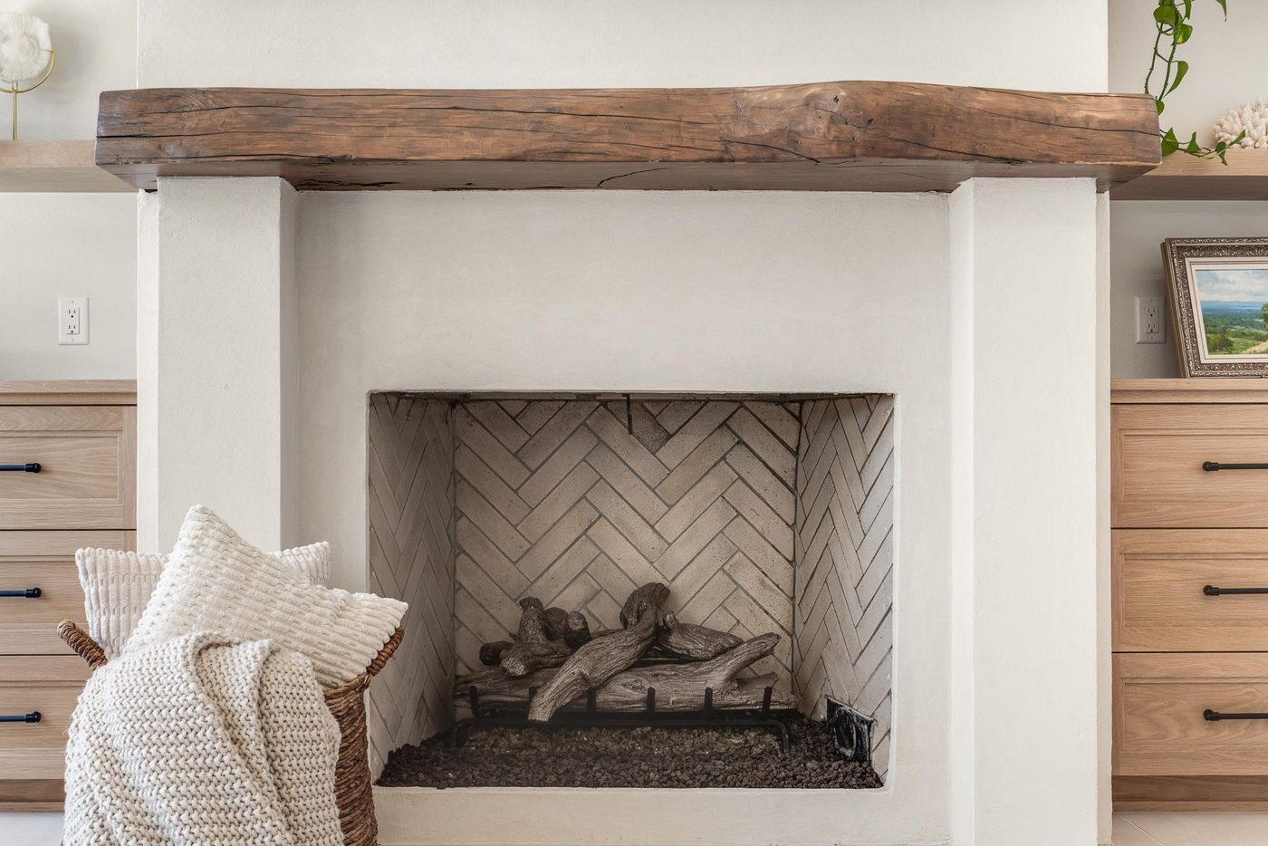 Herringbone brick fireplace with a reclaimed timber mantel