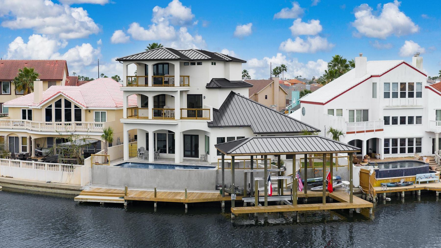 Canal side of the home with a covered boathouse