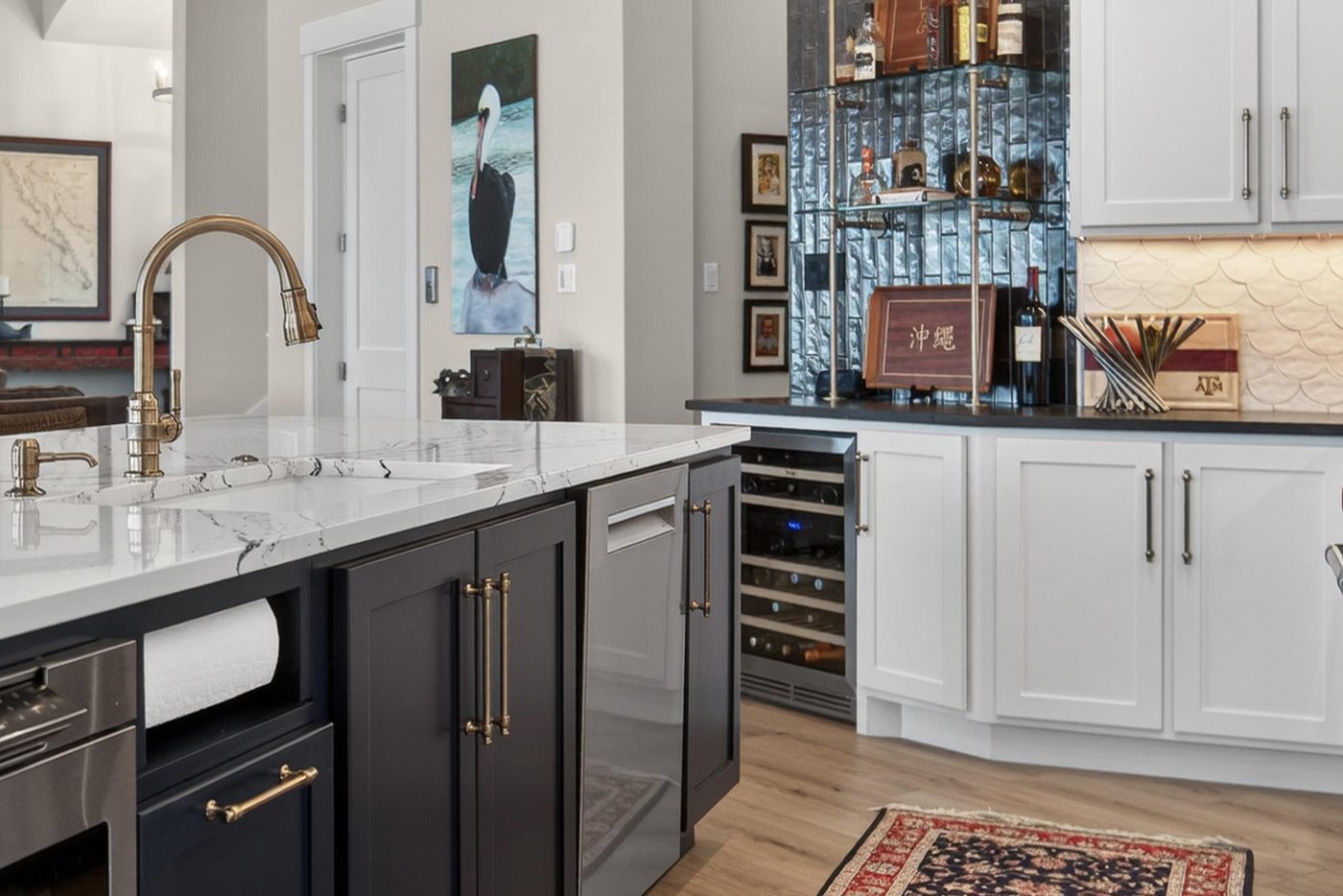 Navy kitchen cabinetry with brass hardware and marble counters