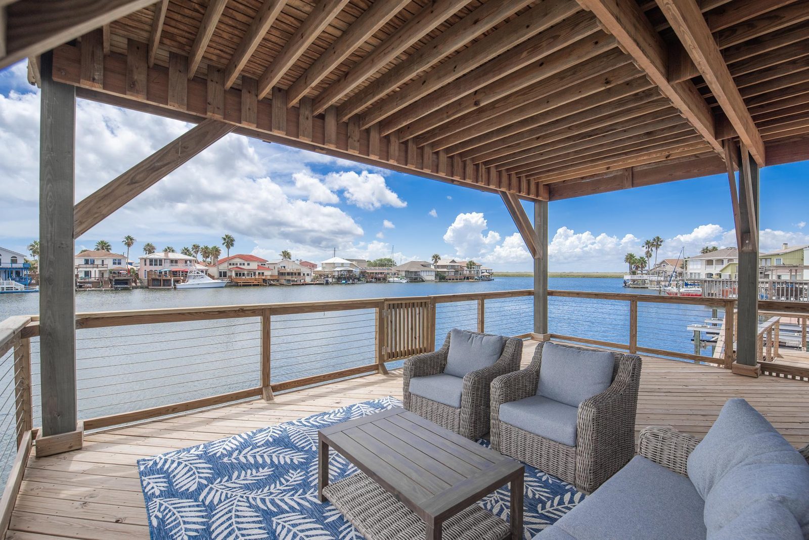 Covered deck with wicker seating overlooking the canal