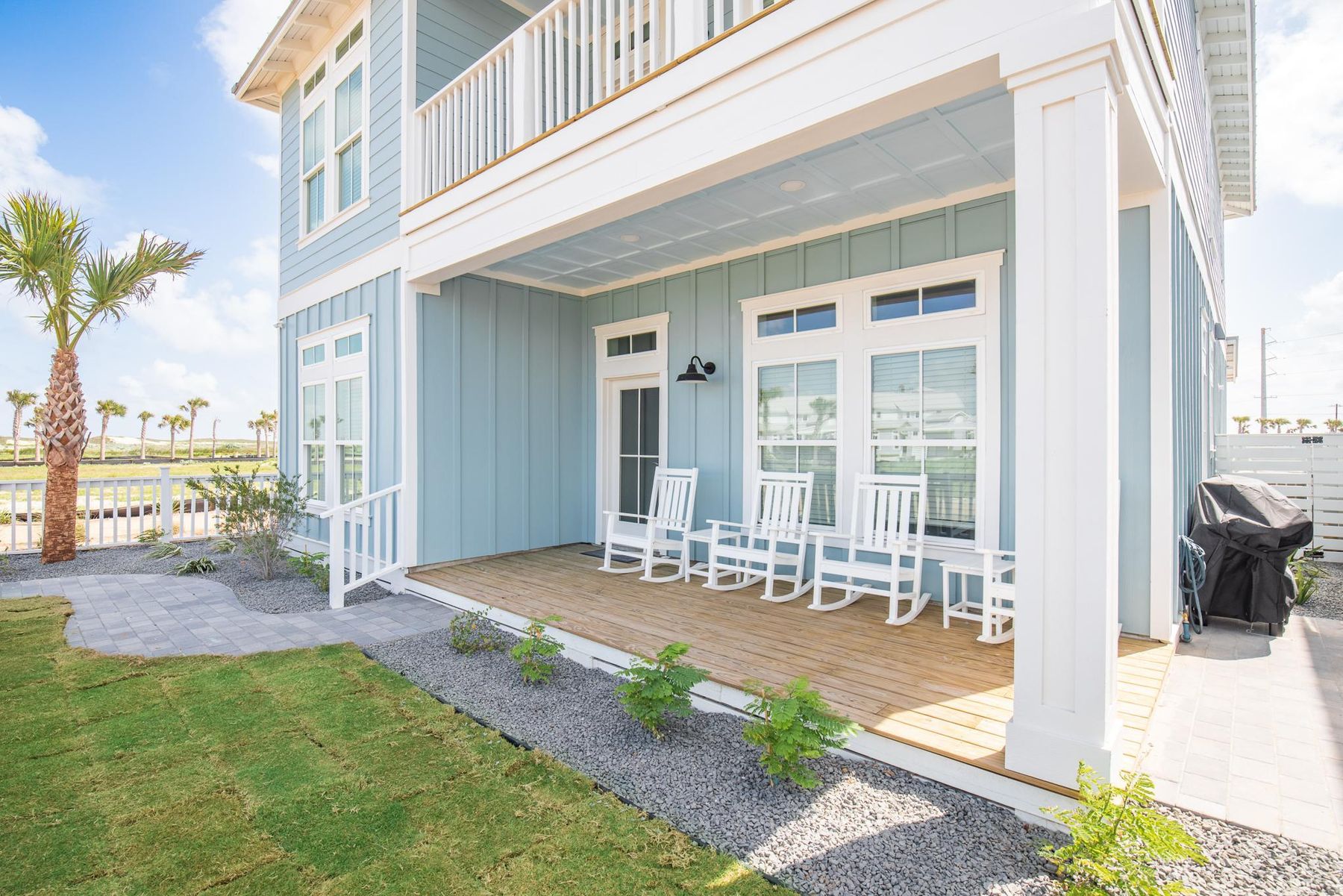Back porch with white rocking chairs